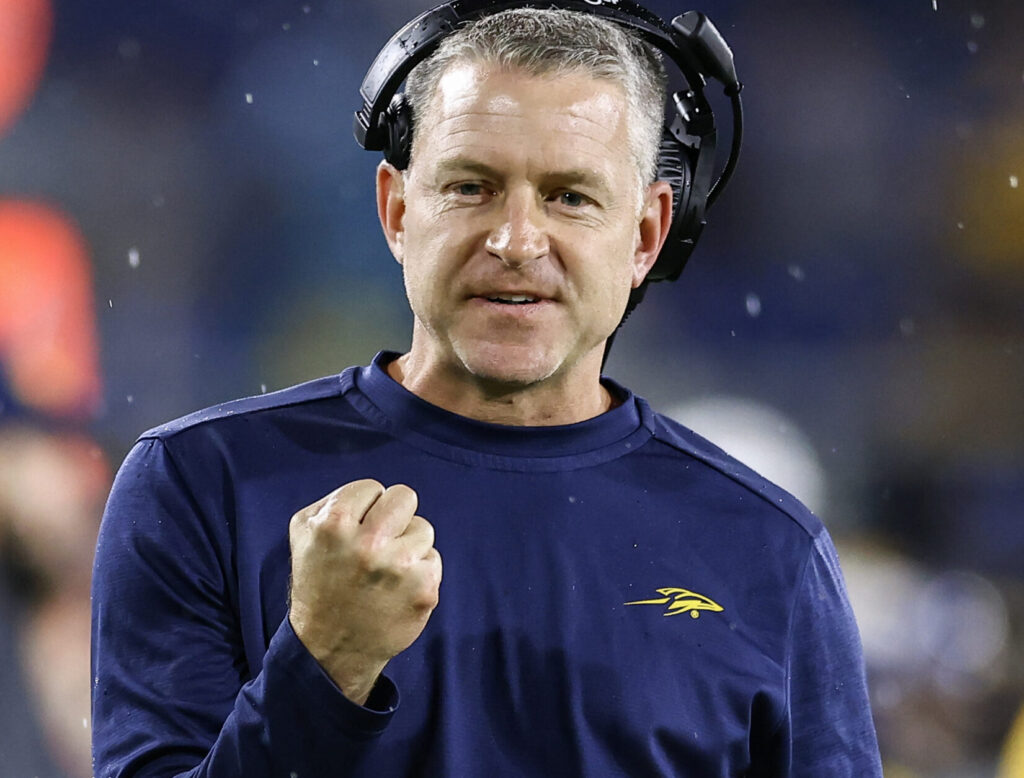 Toledo head coach Jason Candle pumping his fist in approval during a bowl game.